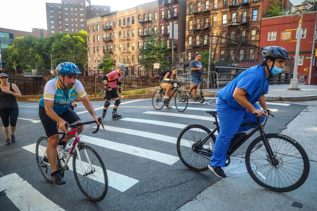 Images of people walking, running, skating and bicycling on vehicle-free city streets in Manhattan.